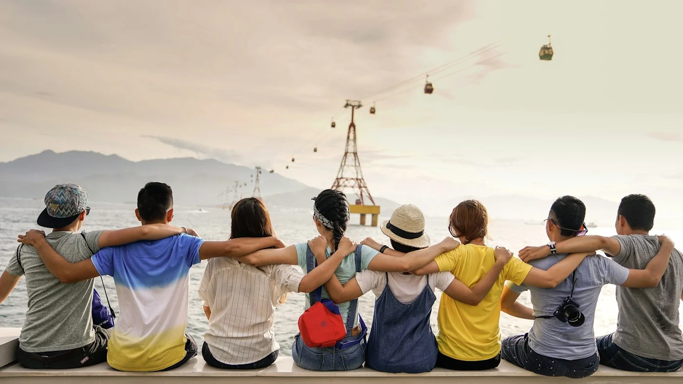 A group of friends spending time together beside the water